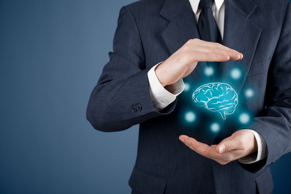 Man In A Suit Holding A Hologram Of A Brain